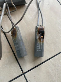a pair of wires on a tiled floor