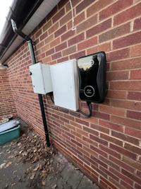 an electric car charging station on the side of a house